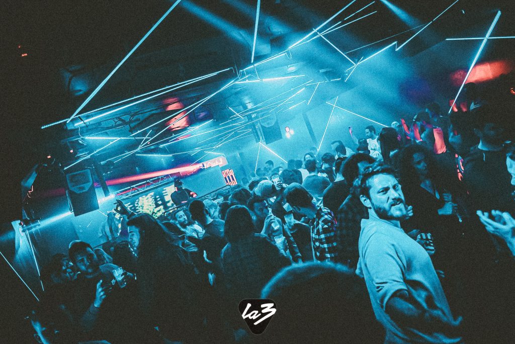 People dancing under blue strobe light in the nightclub La3, in Valencia Spain