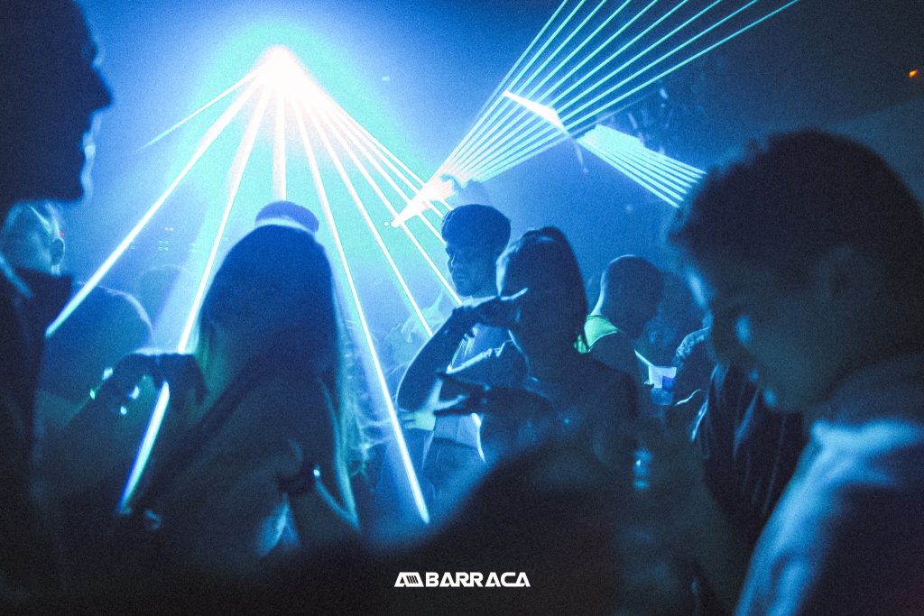 People dancing under blue strobe light in the nightclub Barraca, in Valencia Spain