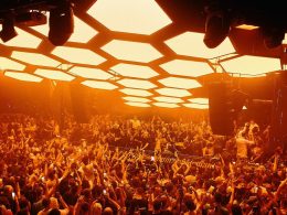 Hexagonal orange lights and crowd dancing at the nightclub Pacha in Ibiza, Spain