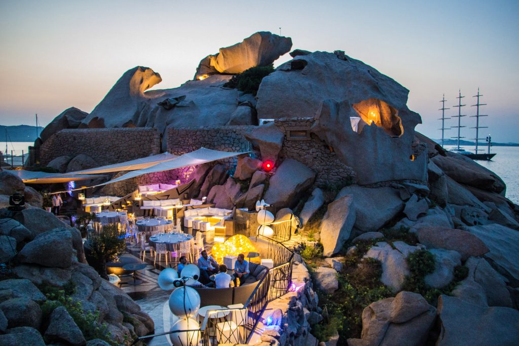 Dinning set up with lights and rocks at The Rock Club in Phi Beach, Italy