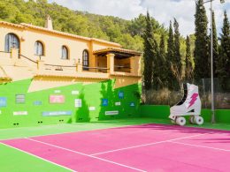 Pink tennis court with decoration in the iconic Pikes Ibiza in Ibiza, Spain