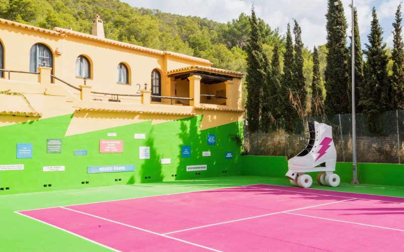 Pink tennis court with decoration in the iconic Pikes Ibiza in Ibiza, Spain