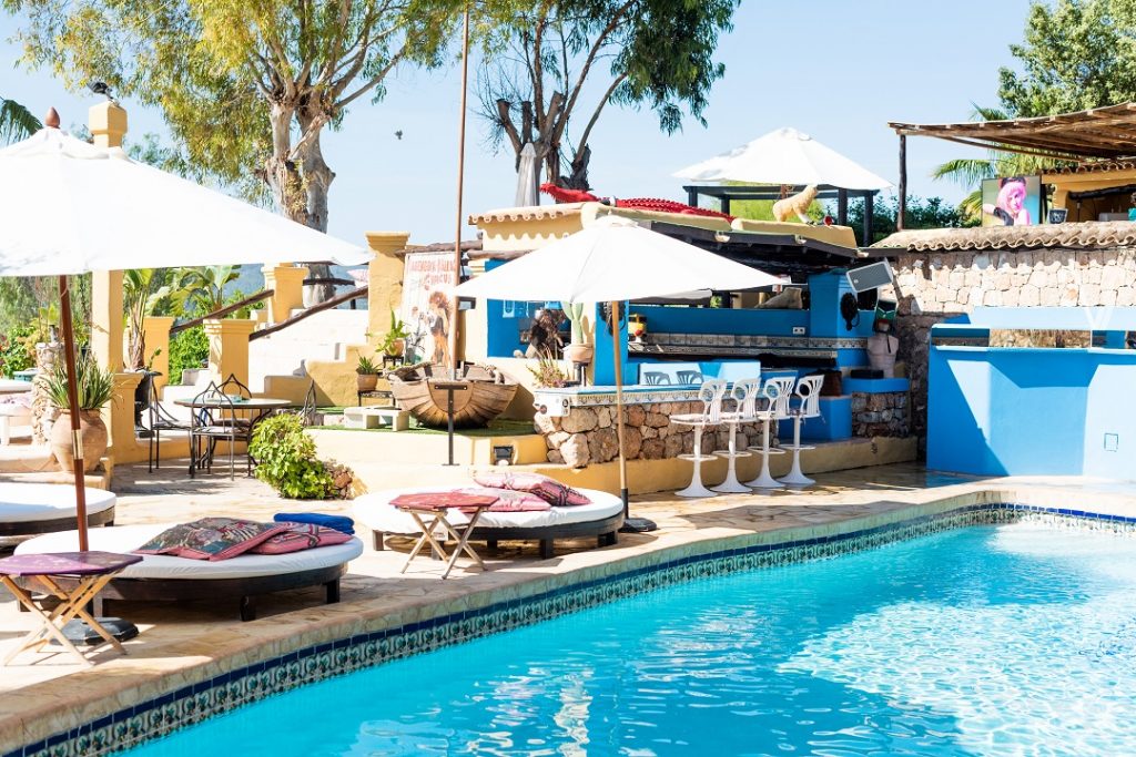 Poolside with umbrellas in the iconic Pikes Ibiza hotel in Ibiza, Spain