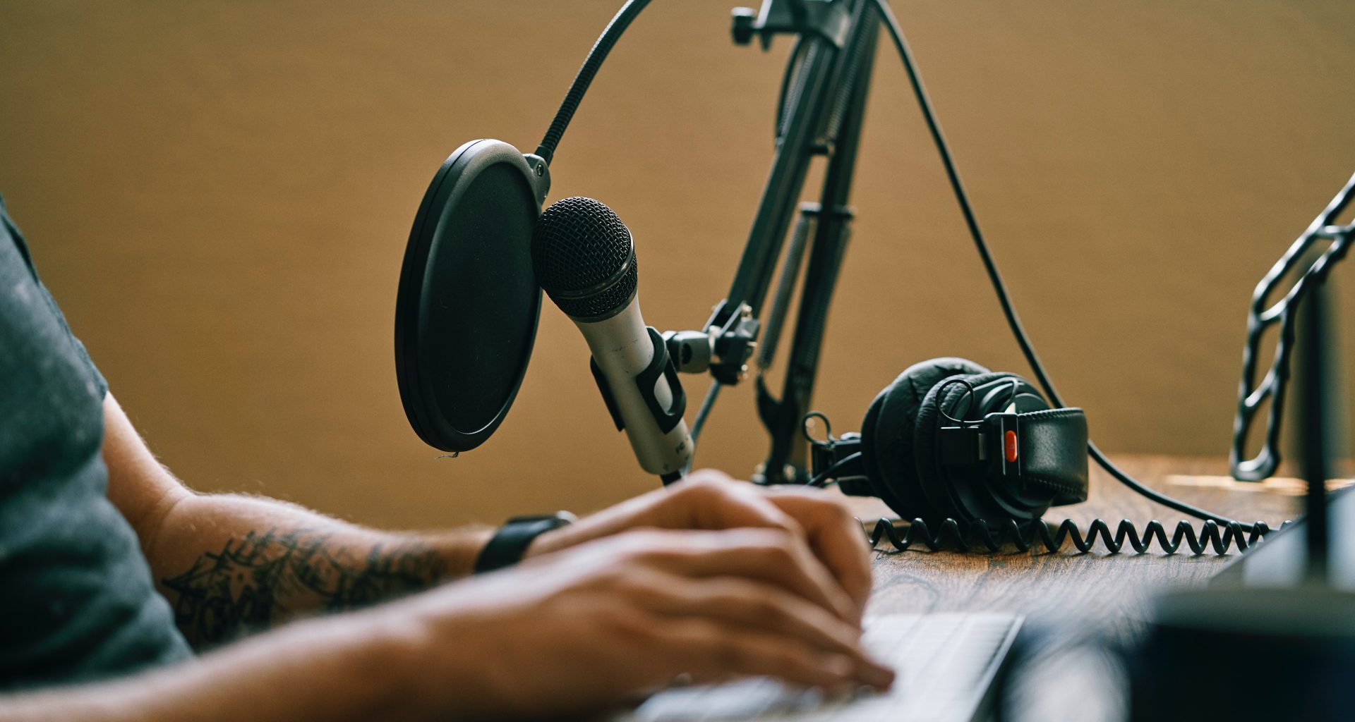 Set up with microphone, headphones and PC to record podcasts music industry