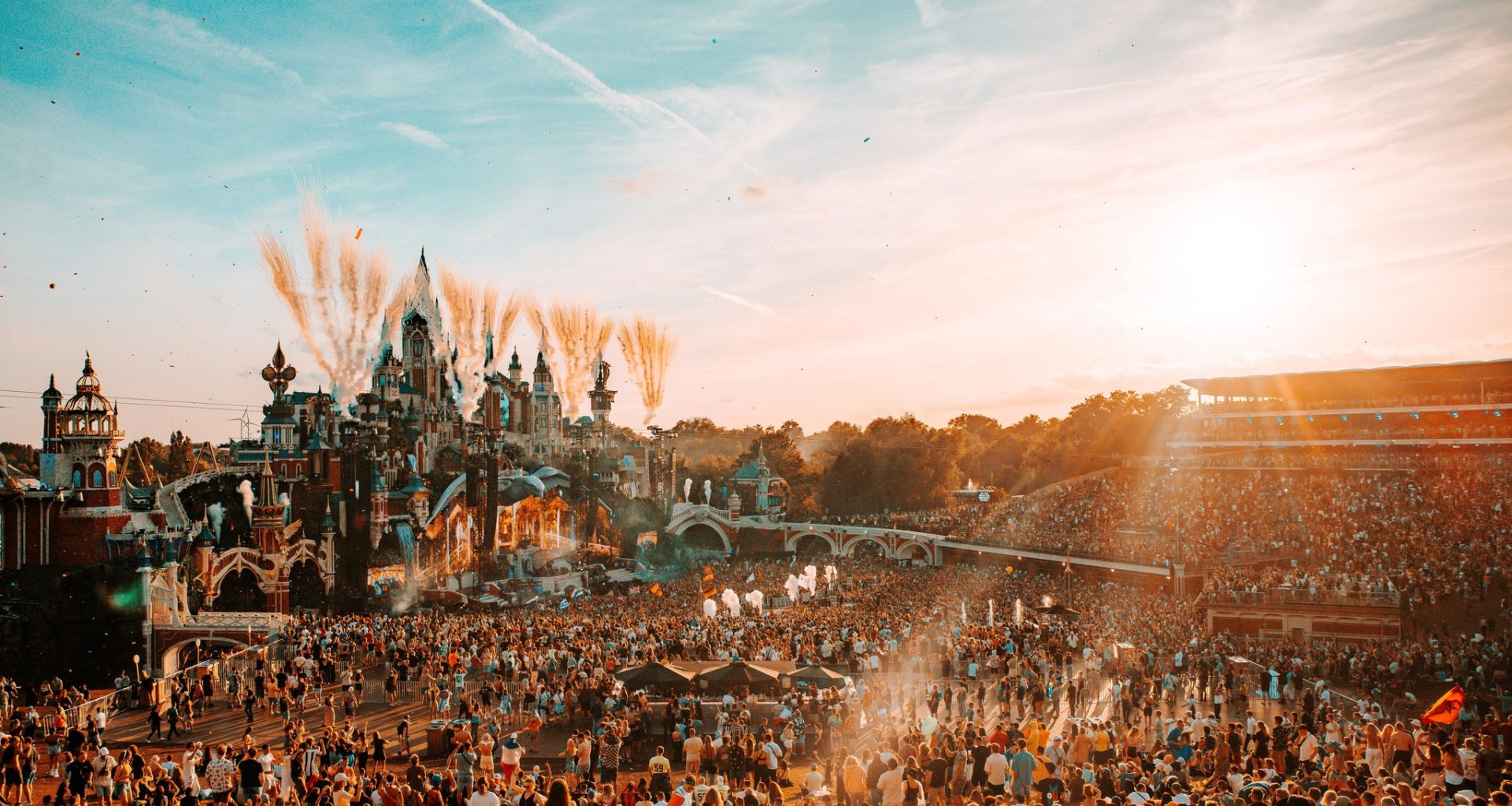 Mainstage of Tomorrowland with huge crowd of people during the sunset