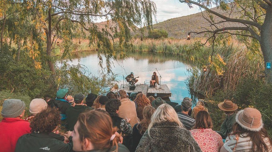 group of people watching others playing instruments at cape town music festivals in a valley 