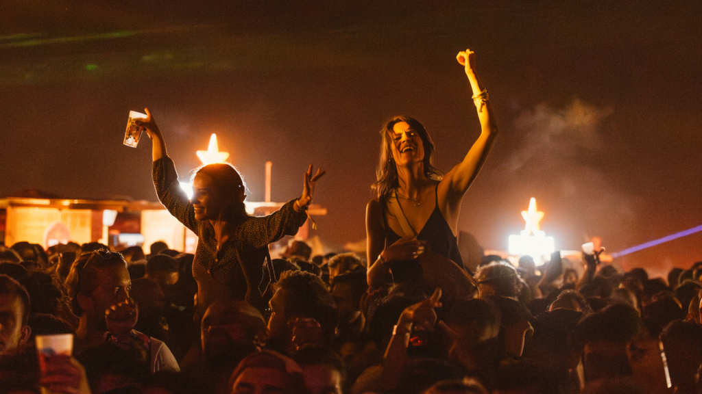 Festival-goers at a beach party near Lisbon