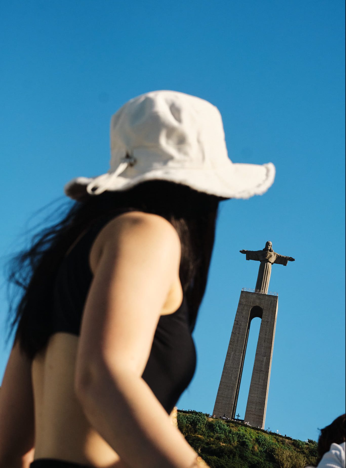 girl looking towards the famour statue in madeira portugal