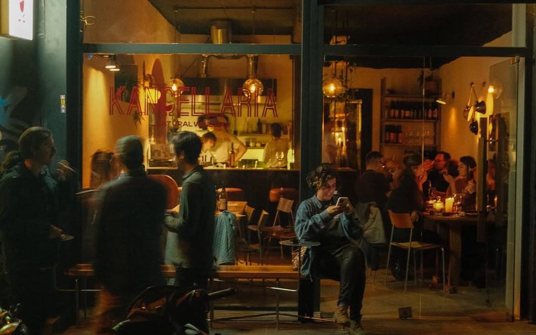 Natural wine bar Kancellaria in Tbilisi lit up at night, popular for its pop-up dinners and vibrant local scene.
