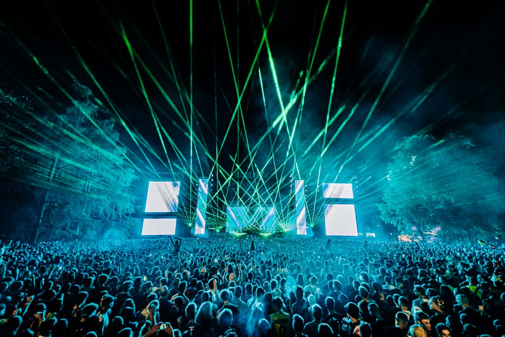 Big stage with lasers in blue and huge crowd at Decibel Open air