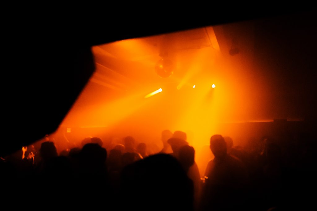 A packed Sound Room during a club night at Public Records, with dancers immersed in warm lighting and hi-fidelity sound.