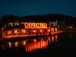 Defected Records Festival sign lighted up by the sea at night in its Croatia edition.