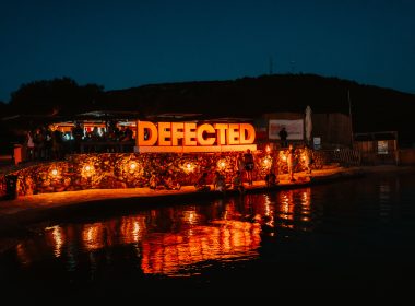Defected Records Festival sign lighted up by the sea at night in its Croatia edition.
