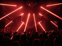 Crowd dancing under red laser lights at INPUT Barcelona 2025 underground club night