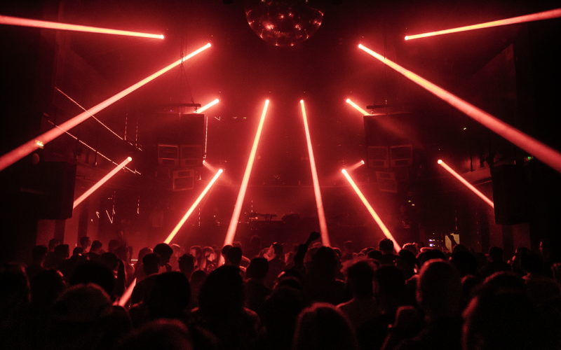 Crowd dancing under red laser lights at INPUT Barcelona 2025 underground club night