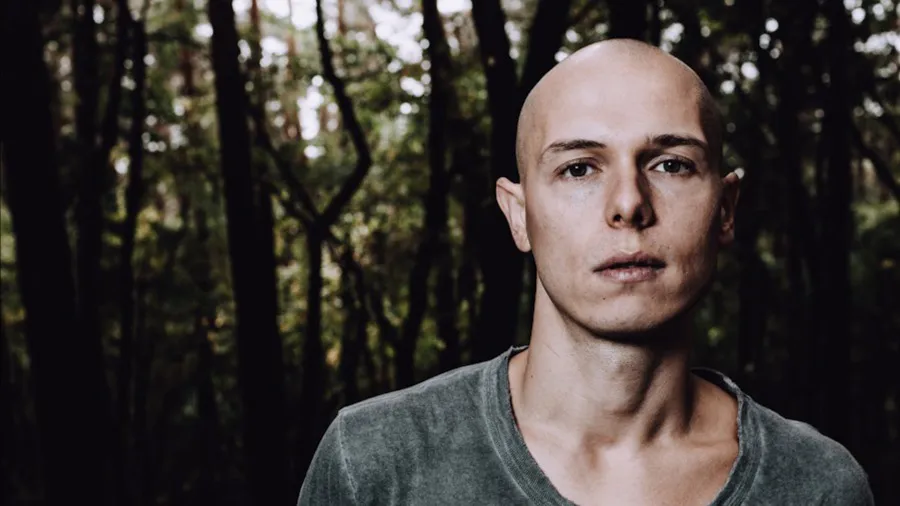 Portrait of Recondite in a forest setting, promoting INPUT Barcelona 2025 event.