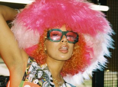 Eliza Rose posing with coloured sunglasses and a big pink furry hat