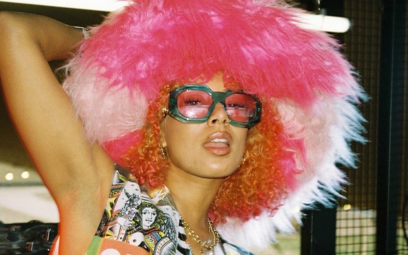 Eliza Rose posing with coloured sunglasses and a big pink furry hat