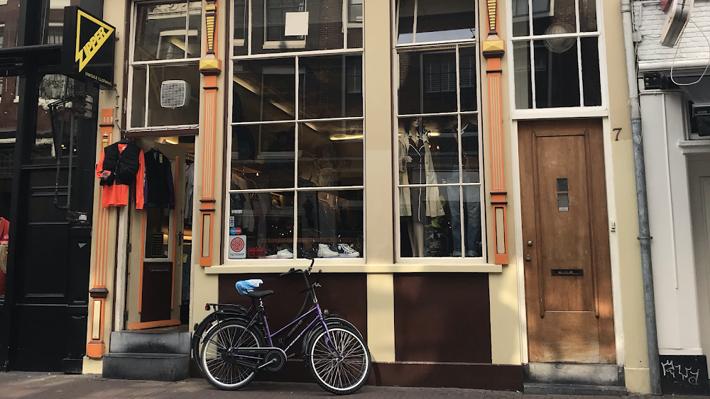 Exterior of the Zipper Vintage Clothing store with clothes in the windows.
