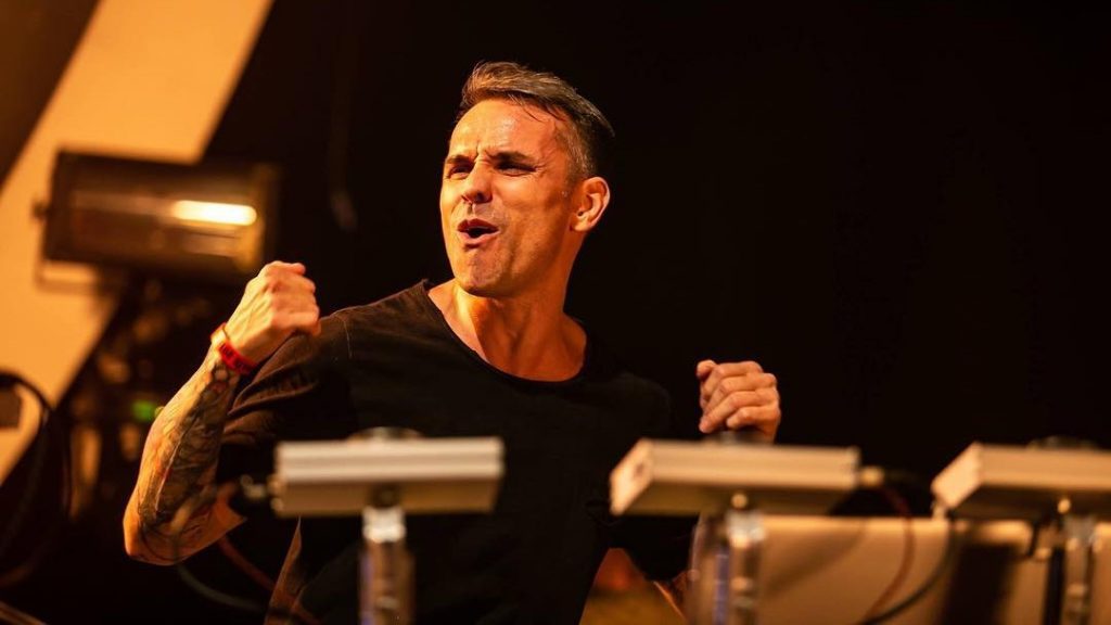 Noize Suppresor DJ onstage playing live at a festival.