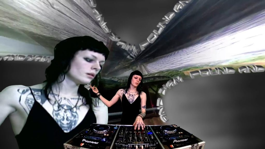 Kabari performing a live set behind Pioneer decks, layered with mirrored visuals and abstract digital graphics, creating a futuristic, immersive electronic music atmosphere.