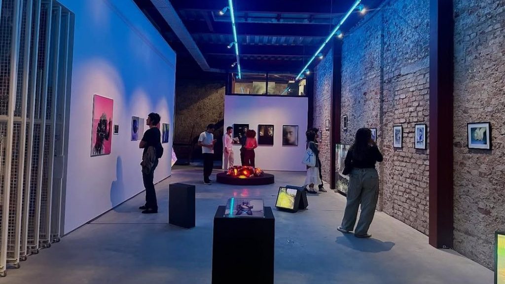 Various visitors observing art on the wall at an exhibition at Refresco Art Gallery in Rio de Janeiro