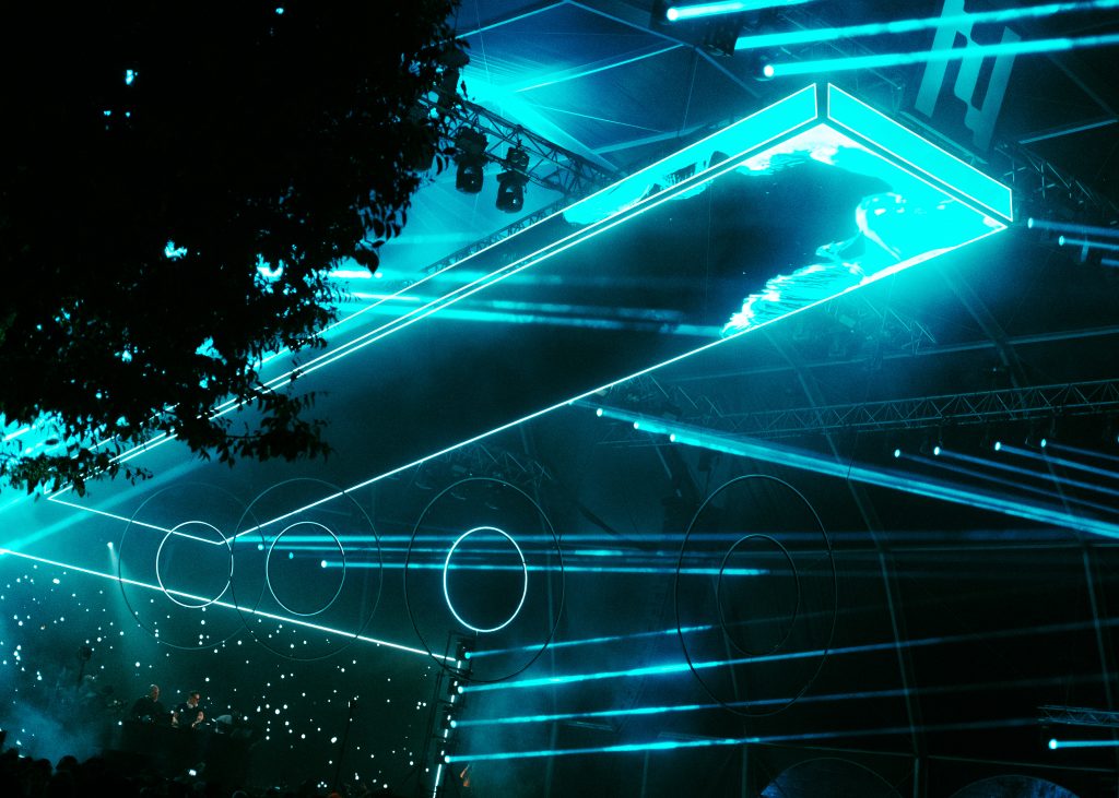 Blue visuals, lights and totems decorating a stage at NEOPOP FESTIVAL 2026